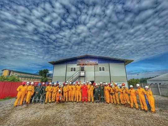 Trainees in fire-resistant suits during a fire safety training session